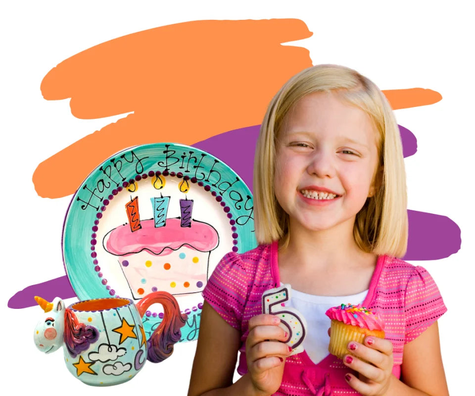 A little girl holding a cupcake with a birthday candle, celebrating her special day at Color Café during a birthday party.